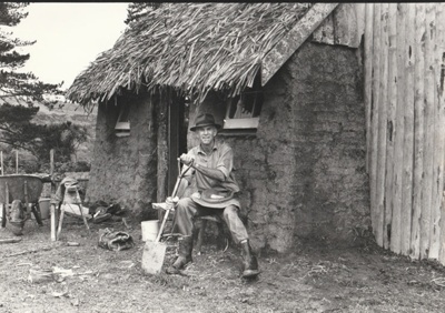 Arthur White in front of the Sod Cottage, Howick Historical Village 
; 6 November 1980; P2020.43.16