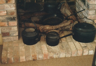 Cooking pots on the hearth in Brindle Cottage in the Howick Historical Village. ; La Roche, Alan; P2021.41.03