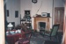 The Puhinui dining room prepared for the filming of 'Savage Play' at Howick Historical Village. ; 1995; P2022.31.11