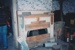 The boarded up fireplace in the front bedroom of Sergent Ford's cottage. ; La Roche, Alan; 1995; P2021.51.08