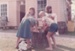 Children washing clothes in a tub outside Johnson's cottage in Howick Historical Village.; La Roche, Alan; March 1982; P2020.122.03