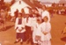 Mark la Roche and a group of girls and a lady, in costume at a Live Day in Howick Historical Village.; La Roche, Alan; 23-23 August 1980; P2021.100.21