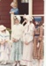 Part of a line of girls in costume standing outside de Quincey's Cottage on a Gala day at Howick Historical Village.; Healey, N; October 1985; P2021.179.04