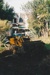 A bulldozer, showing the driver, preparing the way for a Johnson's Heavy truck and trailer to move Puhinui to its new site in the Howick Historical Village.; Alan La Roche; May 2002; P2020.11.31