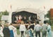 People watching Hungarian dancers on the stage at Howick Historical Village during May Day celebrations.; May 1990; P2021.169.04