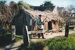 Frank Jones dressed as a soldier, in front of the sod cottage in the Howick Historical Village. ; La Roche, Alan; c2000; P2020.50.23
