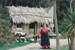 Debbie Benson in costume as Maggie Thompson in front of the sod cottage on a Live Day at  HHV.; December 2002; 2019.199.08