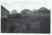 Looking over a garden to the Courthouse and cottages on Grey Street, Howick Historical Village; La Roche, Alan; 1981; P2020.124.01