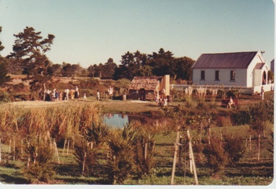 Looking across the pond to the sod cottage and Methodist Church; 1981; 2019.122.09