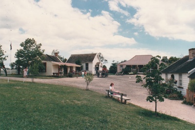 Christmas, past and present at Howick Historical Village. 12 December 1987. Looking towards Brindle cottage, the Couthouse, Eckford's Homesread and Briody-McDaniel Cottage.; Ashby, Frank; 12 December 1987; P2021.190.11