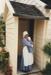 Jane Martinson and a baby in costume, in the doorway of Briody's cottage in Howick Historical Village.; P2021.105.33