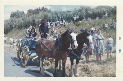 A pair of Clydesdales pulling a wagon on Howick beach, watched by onlookers, preparing to take part in the 1947 Centennial Celebrations.; 8 November 1947; P2022.38.49