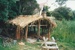Hemi Pepene's whare (cottage) at the Howick Historical Village, showing the raupo thatched roof.; La Roche, Alan; December 2000; P2020.96.09