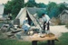 Museum guides acting as a Fencible and his wife, by the fire outside the tent on the green at Howick Historical Village. ; La Roche, Alan; August  1995; P2020.88.07