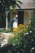 Lois Abram in costume on the verandah of Sergeant Barry's cottage in Howick Historical Village. ; La Roche, Alan; February 1992; P2020.134.09
