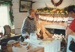 Christmas, past and present at Howick Historical Village, 12 December 1987. Claire Lee in costume, making butter in Johnson's Cottage.; La Roche, Alan; 12 December 1987; P2021.193.02