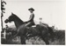 Norman Robertson in his WWII uniform mounted on his horse outside his parents' home in Gills Road.; 1939; P2022.67.01