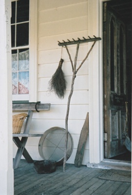The verandah of Fitzpatrick's Cottage at Howick Historical Village, showing household items..; La Roche, Alan; P2021.80.02