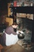 A woman, in costume, cooking in the fireplace in Sergeant Ford's cottage in Howick Historical Village.; La Roche, Alan; P2021.98.02