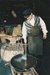 An unnamed volunteer cooling the iron in Wagstaff's Forge in Howick Historical Village on a Live Day.; La Roche, Alan; c2000; P2021.03.01