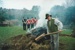 Alan la Roche using a rake on the charcoal kiln in Howick Historical Village.; La Roche, Alan; P2021.118.22