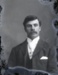 Male portrait, wearing Boer War tie and Raleigh pin; 89