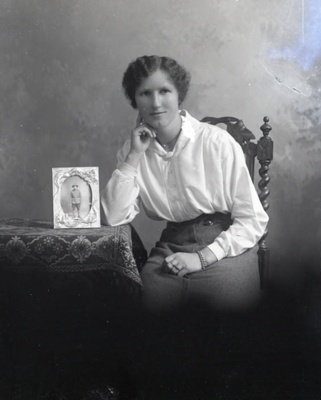 Female portrait with soldier photograph; 10