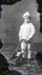 Child in knitted suit with trolley; 563