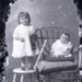 Baby and girl with knitted sailor doll; 666