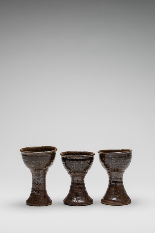 Set of three rustic goblets, textured with pitting.