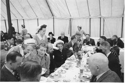 Photo: Jack Phillips, Manager of the 1949 New Zealand Cricket Team, and guests, enjoying lunch in a marquee during the traditional fixture against the Maori CC., Worcester Park, Surrey, 5.5.1949;...