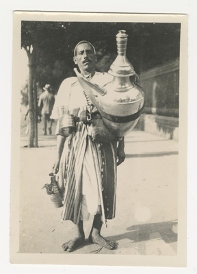 Photograph, North African man with large Urn.1940s. image item