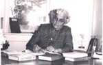 Photo: Mrs. Charlotte Wright (nee Templeton) at Russell library desk.; 97/733