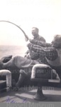 Photo: Zane Grey playing a gamefish, c1931; 98/329/6