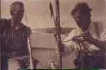 Photo: Harold Vipond and Syd Irving with harpoon bent by shark, 1940's; 99/1402