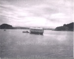 Photo: House being transported by barge and launch between Russell and Paihia, 1950's; 93/15/2 Photo: House being transported by barge and launch between Russell and Paihia, 1950's; 93/15/2
