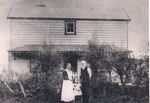 Photo: Tudor Collins parents outside a cottage; 97/420