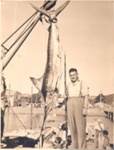 Photo: Angler with gamefish, Russell wharf, c1950's; 97/636