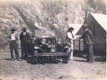 W.P Baker, W Rummins, E.C Arlidge and an unknown man with car at a camp.; Unknown; 97/1447