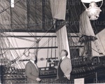 Photo: George Rattray and Frank Miller beside Endeavour model, c1970; 97/1568