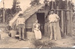 Photo: Gum digger's hut with three people outside; 92/21/3