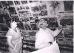 Photo: Paula Gill and Marie King inspecting historic papering in attic, Russell Police Station 1983; 04/69