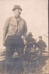 Photo: Herbert Francis Cook at the wheel of the "Waiwiri" c1900; 97/417