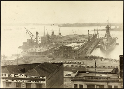 Photograph: Construction of Princes Wharf, with warship HMS HOOD (1920) alongside, 1924.; Auckland Harbour Board. Engineer's Dept.; 2010.132.62