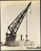 Photograph: Floating crane lifting concrete caisson, 1913.; Auckland Harbour Board. Engineer's Dept.; 2010.132.230