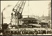Photograph: Floating crane lifting launch shelter, 1922.; Auckland Harbour Board. Engineer's Dept.; 2010.132.266