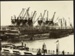 Photograph: Seven electric cranes working SS KAIAPOI at Princes Wharf, 1926.; Auckland Harbour Board. Engineer's Dept.; 2010.132.300