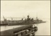 Photograph: Construction of Princes Wharf, with warship HMS HOOD (1920) alongside, 1924.; Auckland Harbour Board. Engineer's Dept.; 2010.132.61