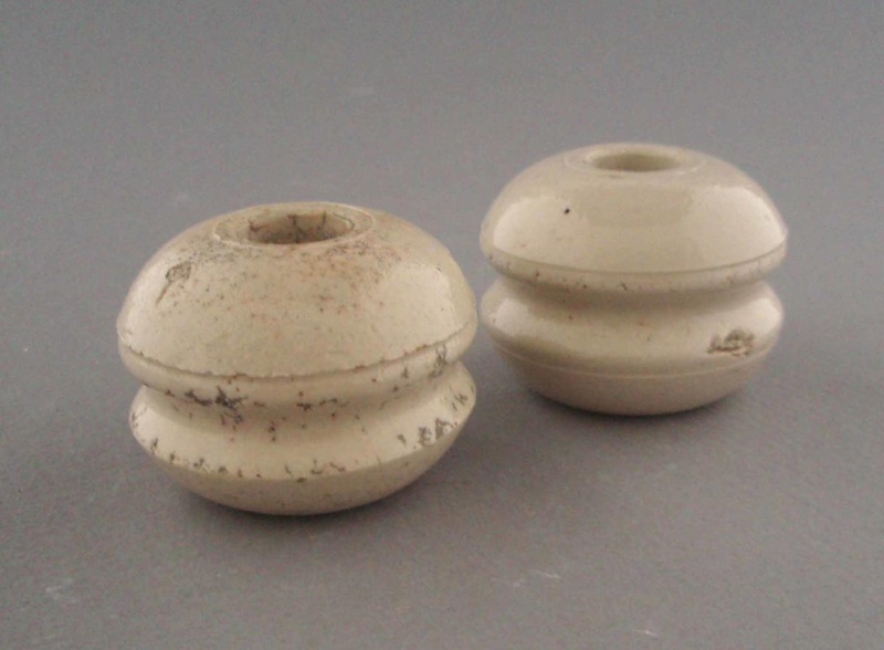 Two bobbin insulators; Crown Lynn Technical Ceramics Limited; 1930-1965; 2009.1.1293.1-2