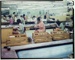 Transparency - Workers at benches on factory floor, hand painting plates, large crates of crockery beside them; 1960s; 2008.1.3048